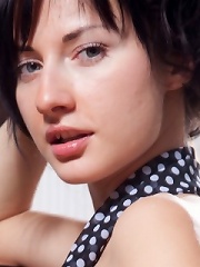 Curly brunette teen takes off her sheer clothes